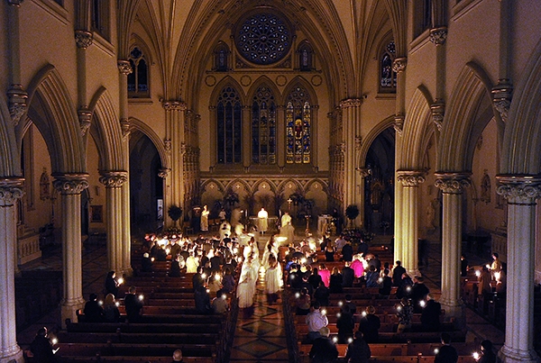 The Easter Vigil Mass at St. Joseph Cathedral in darkness, lit only by candlelight. (Dan Cappellazzo/Staff Photographer)